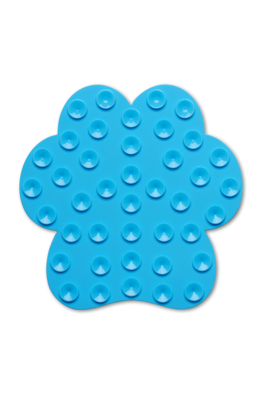 A bright blue silicone sensory mat shaped like a paw, featuring multiple raised circular bumps, shown on a plain white background.