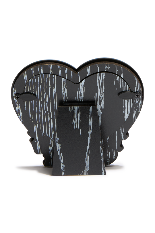 A black heart-shaped backing of a decorative frame with a white vertical wood pattern, standing on a rectangular base against a plain white background.