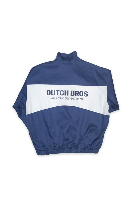 A navy blue and white windbreaker jacket shown from the back, featuring a large white horizontal stripe across the upper back with 'DUTCH BROS ATHLETIC DEPARTMENT' printed in navy blue text.