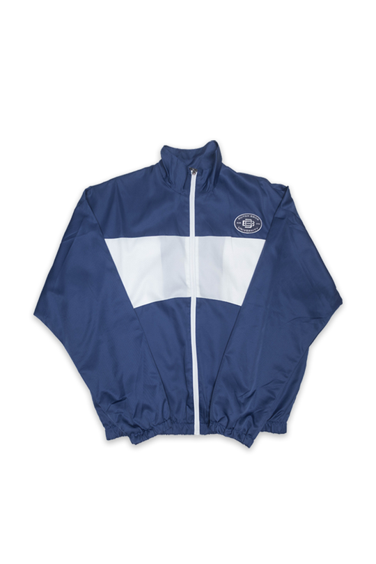 A navy blue and white windbreaker track jacket with a front zipper, elastic cuffs, and a circular chest patch, shown flat on a white background.