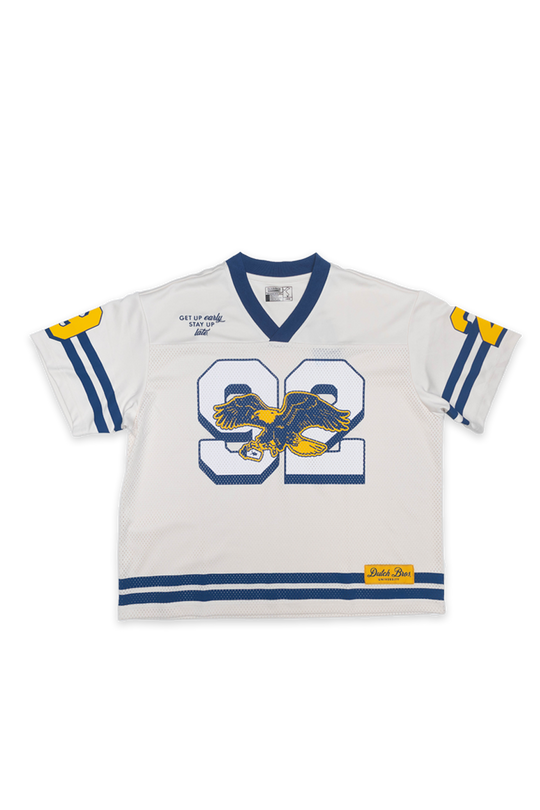 white and navy blue football jersey with 92 and an eagle logo on the front.