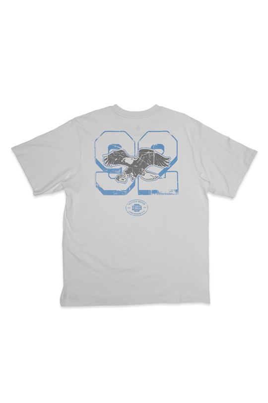 A light gray short-sleeve t-shirt with a distressed blue and black graphic on the back featuring the number 92 and an eagle design.