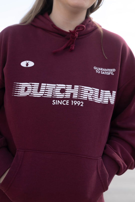 Maroon hoodie with 'Dutch Run' branding on a neutral background