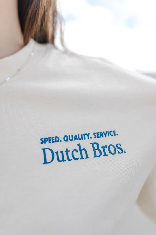 White shirt with 'Dutch Bros' logo and text on a blurred background