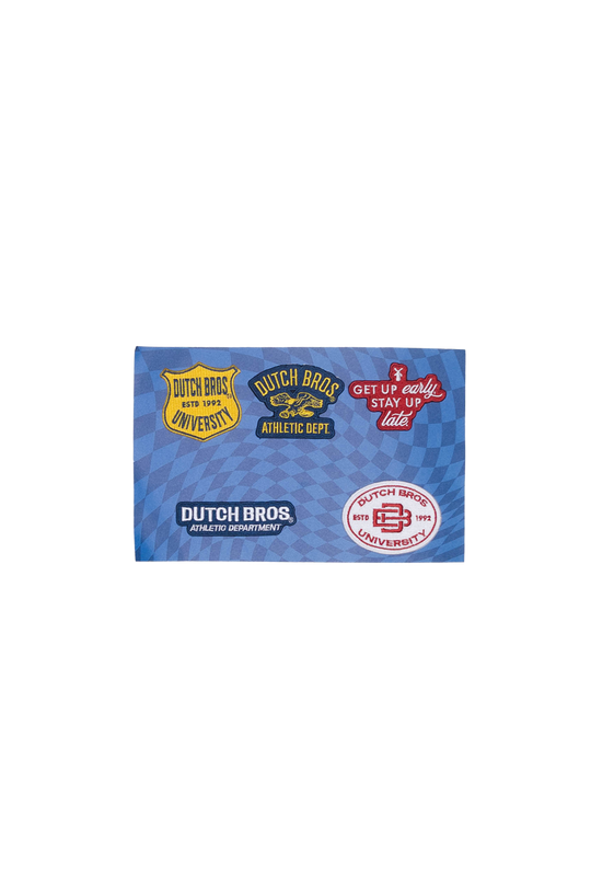 A rectangular blue fabric square featuring multiple Dutch Bros patches 